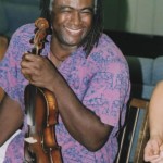 Appalachian musician Earl White holding a fiddle