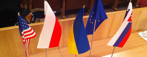 Flags of USA, Poland, Ukraine, European Union, and Slovak Republic on the speakers' table.