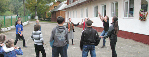 Students and delegates playing volleyball and football (soccer)
