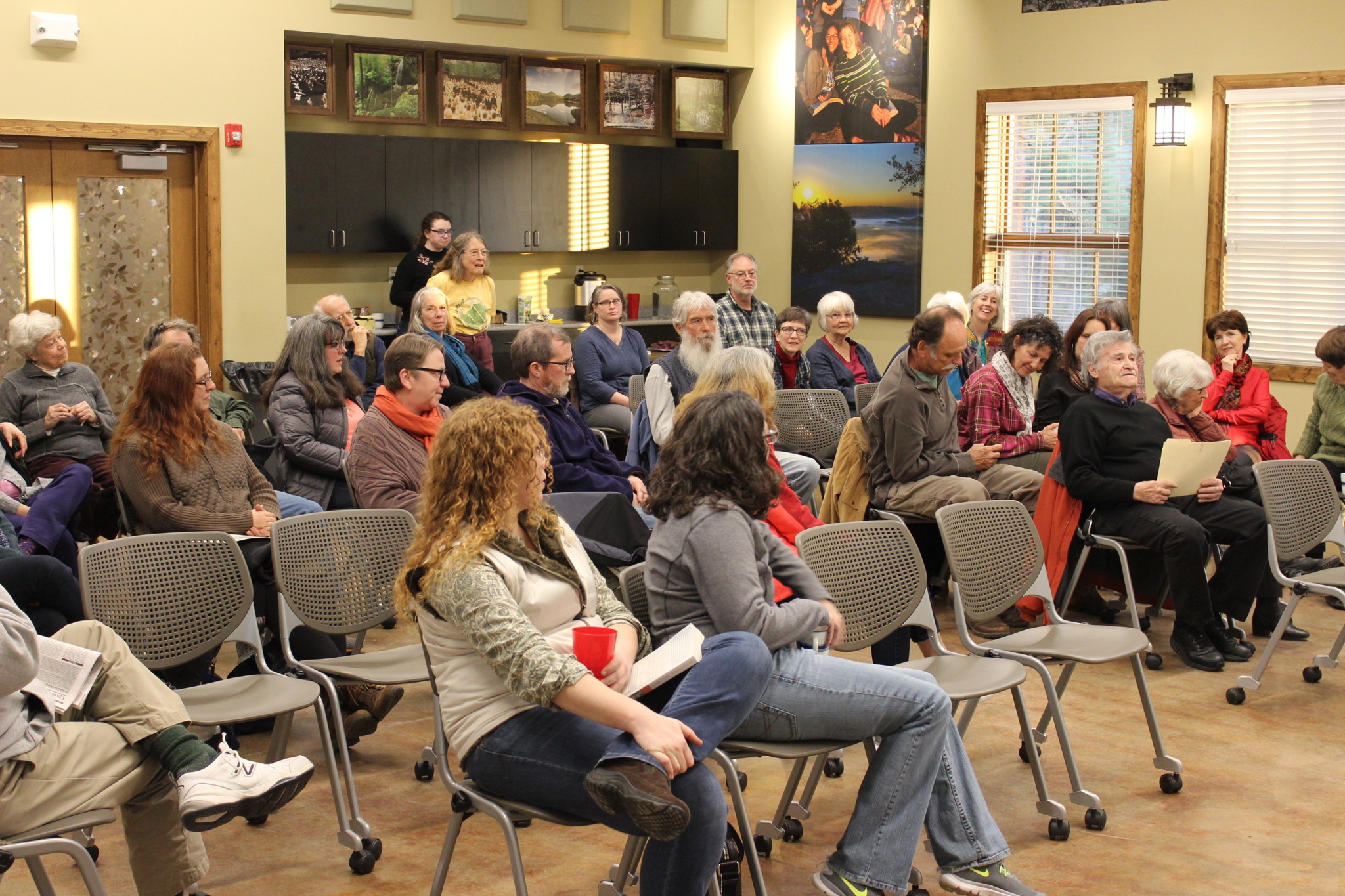 Large gathering of community members for documentary viewing