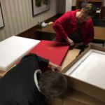 Rachel & Rev. Loretta Reynolds, College Chaplain, opening the first book.