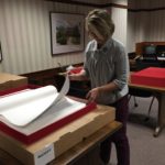 Marsha Elliott, CCC Admin Asst., inspecting the volumes