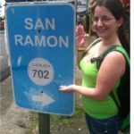 Jennifer Blume pointing at San Ramon sign