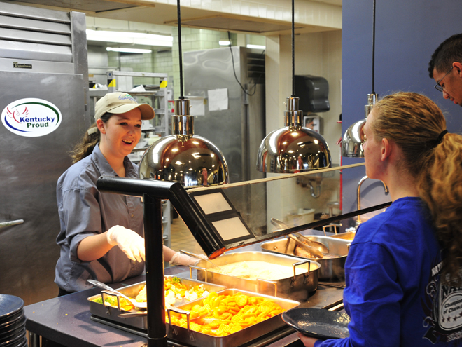 Student workers serve students their meals in food service