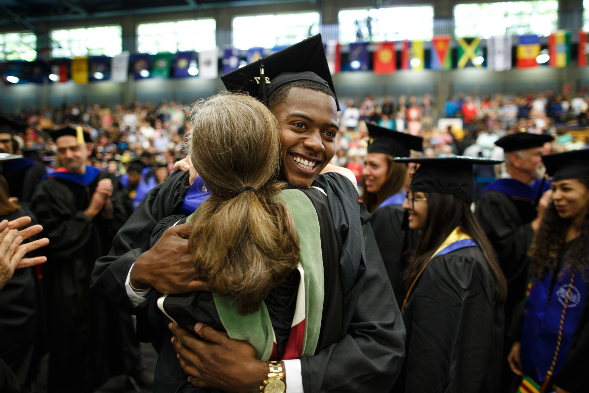 A recent graduate gives someone a hug