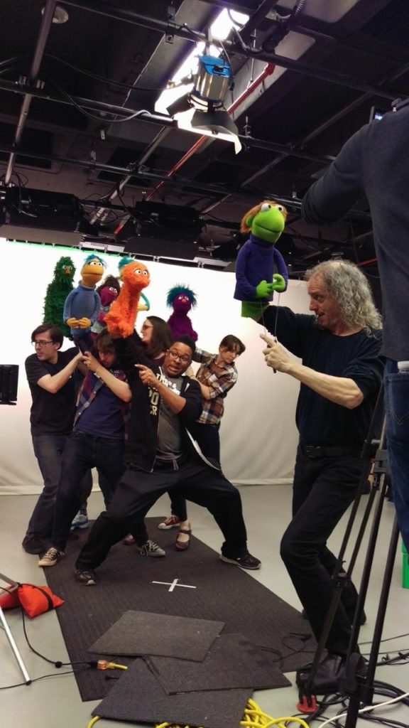 Alumnus Hayes and other cast members on set at Sesame Street