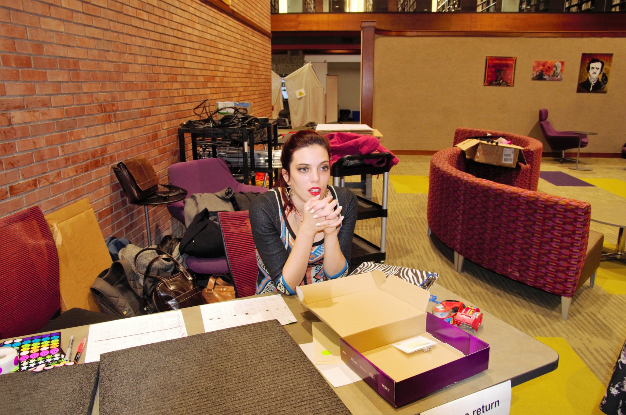 Student sitting at the entrance table of 410 expo