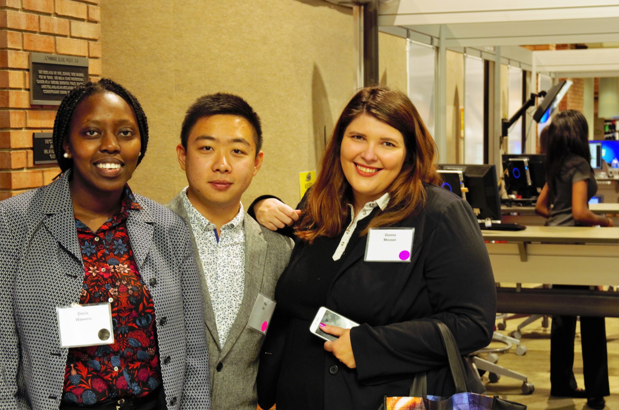 Three students posing for a picture at GSTR 410 Expo: Fall, 2016