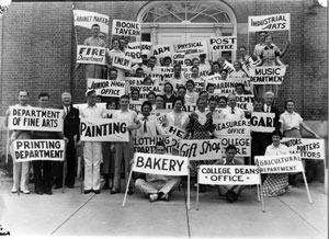 White and black picture of students holding signs on labor day
