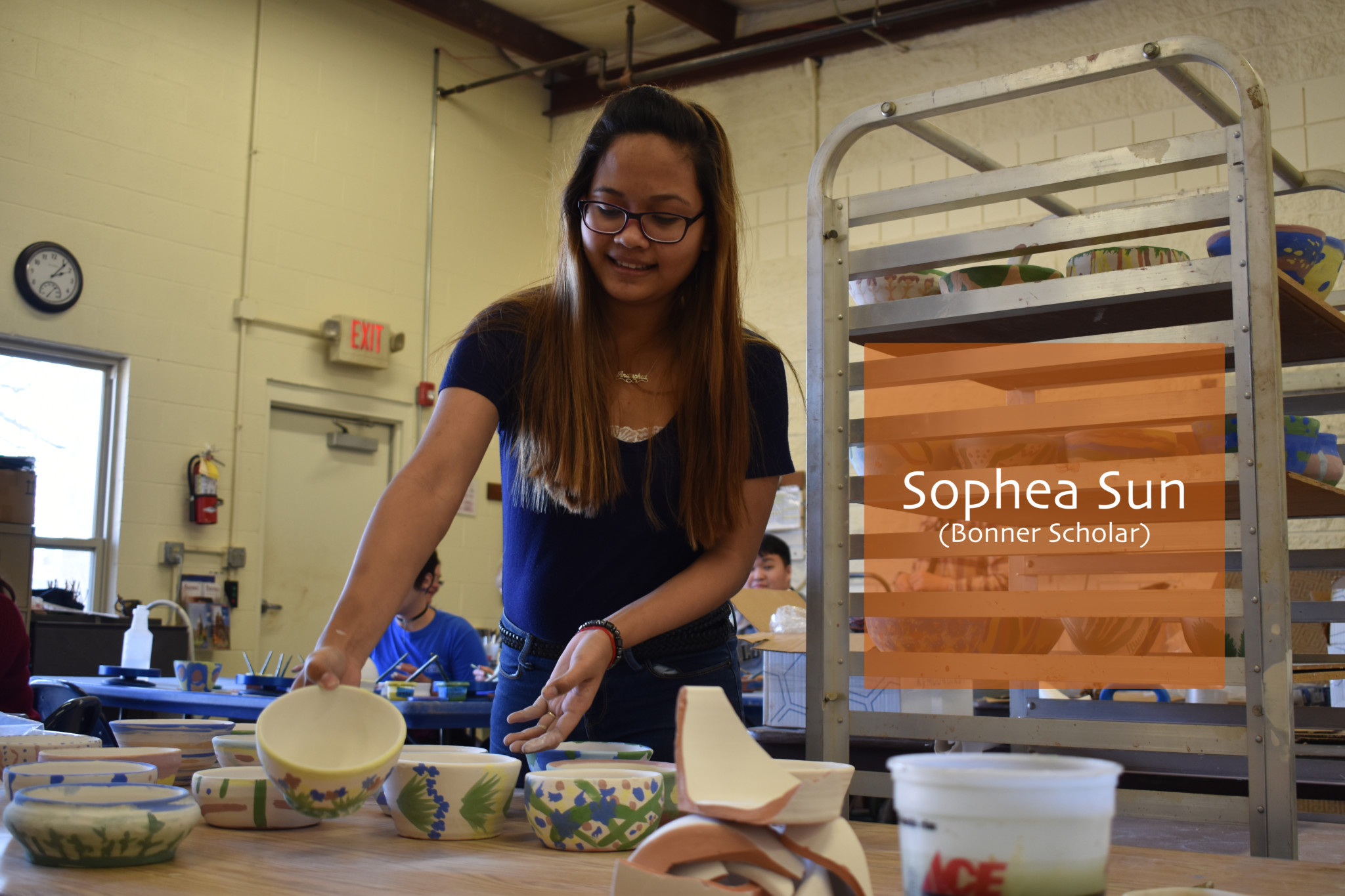 Sophea, a bonner scholar decorates bowls for Partner for Education