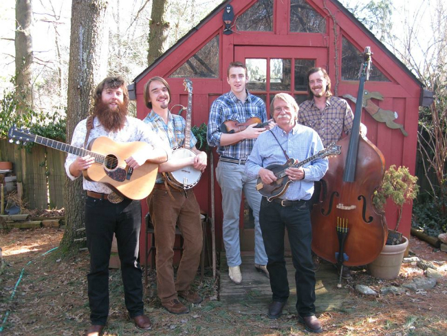 Bluegrass Ensemble in front of a red building