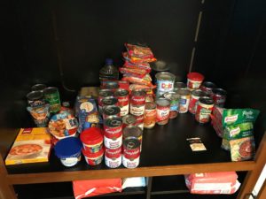 A food closet filled with non-perishable food items.