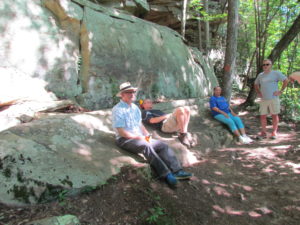 Chad Berry, Scott Steele, Linda Strong-Leek, Jim Strand sitting under a mountain at Cumberland falls