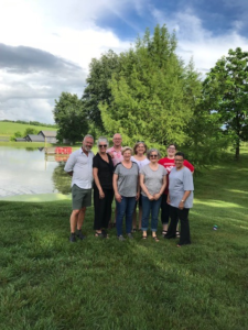 Photo of AVP Office members outdoors near a pond on a gorgeous summer day