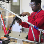 picture of a student welding bicycle