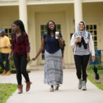 Three students from different countries walking together