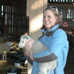 A student holding lamb at the farm of berea college