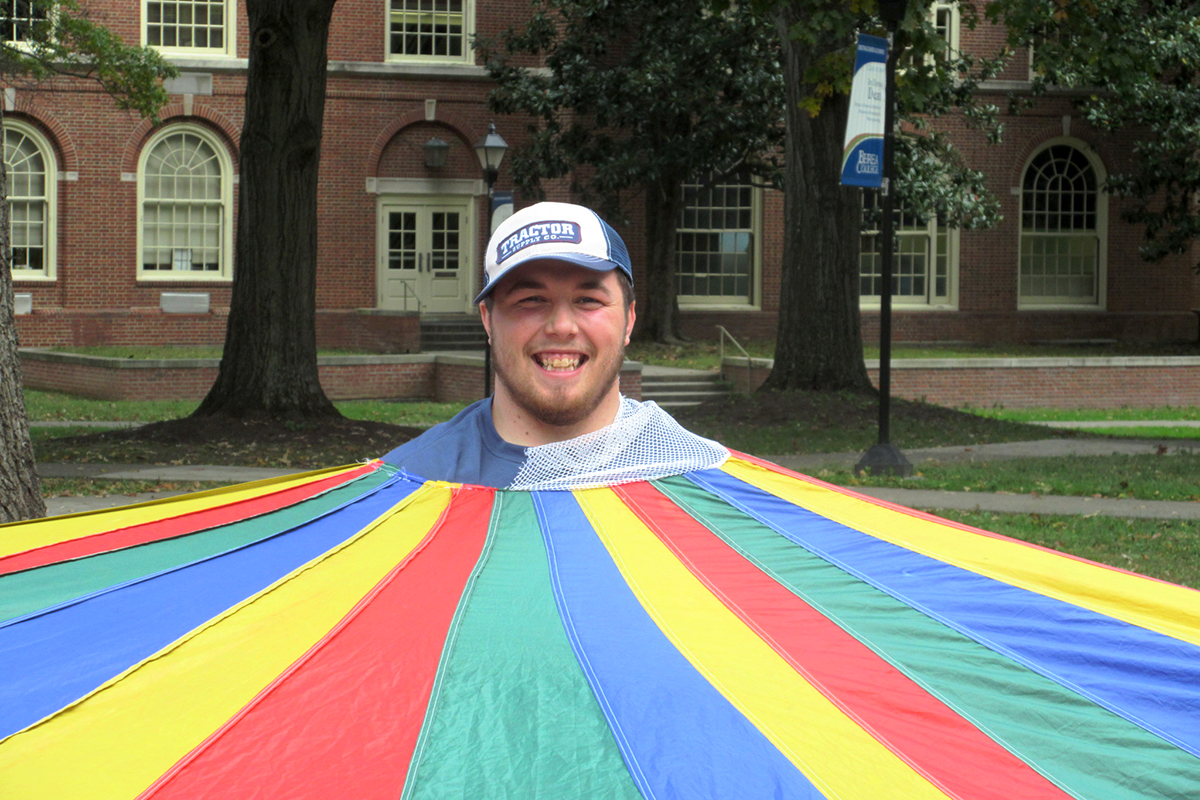 Student in a parachute smiling
