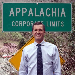 President Lyle Roelofs in front of a sign reading "Appalachia Corporate Limits"