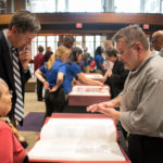 Calvin Gross, Associate Directory of Library Services, shows a volume of the St. John's Bible