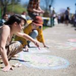 Festival attendees covered the sidewalk in chalk art