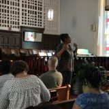 Dr. Kathy Bullock speaking as part of a discussion group in the sanctuary of Dexter Avenue Baptist Church