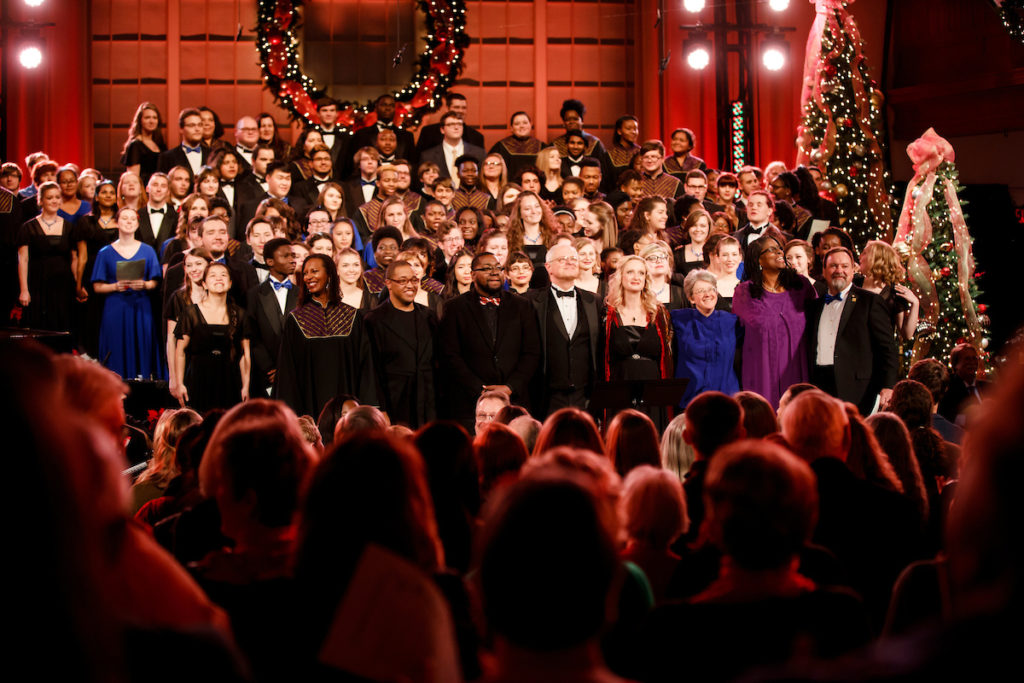 Musical ensemble members and directors standing in front of audience at the Christmas concert, 2016.