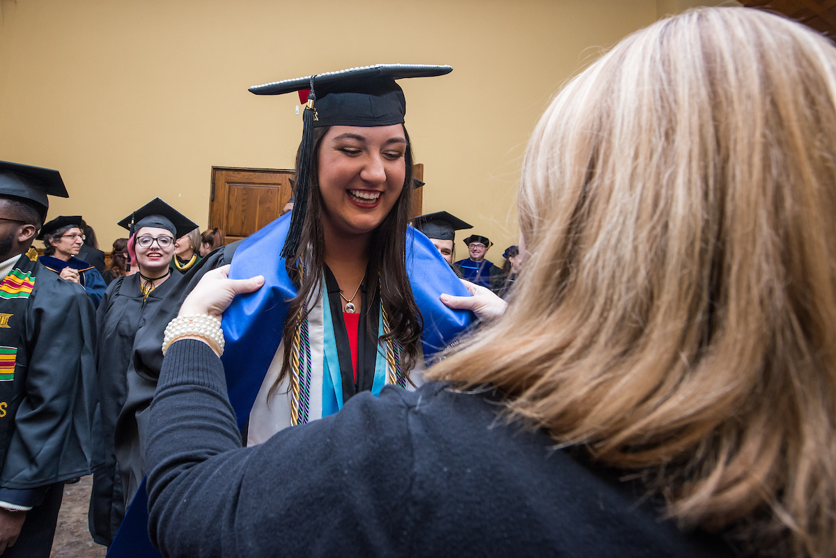 Smiling graduate receives her stole